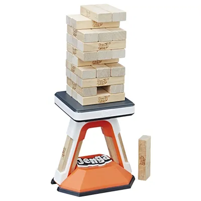 A Jenga Pass Challenge game tower is set up on its base, with one block removed and placed to the side.