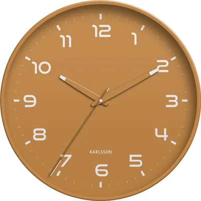 A close-up view of a round wall clock with an ochre-colored face and white numbers and hands.
