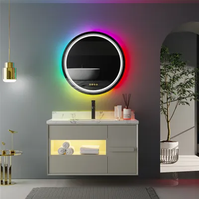 A modern bathroom vanity with a round LED mirror, sink, faucet, and decorative items.