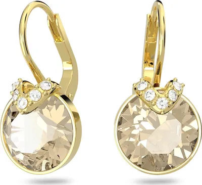 A pair of gold-colored earrings with large champagne-colored crystals and smaller clear crystals.
