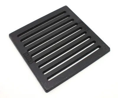 A black cast iron grate on a white background.