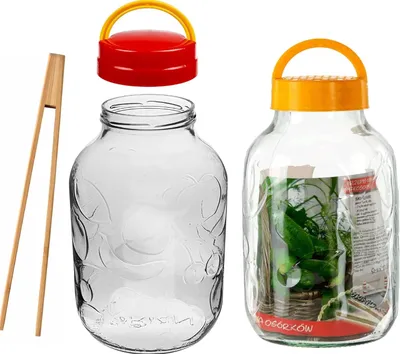 A set of two empty glass jars with lids and a pair of tongs, and one jar filled with pickles and a label.