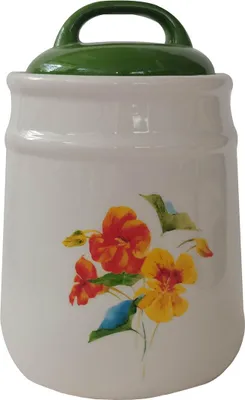 A white ceramic jar with a green lid and a floral pattern.