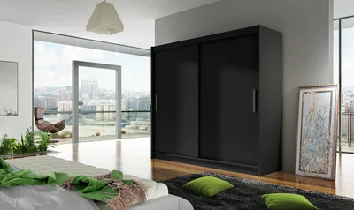 A modern bedroom with a large window overlooking a city, featuring a black sliding door wardrobe.