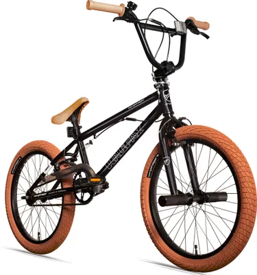 A black BMX bicycle with tan tires and seat, presented against a white background.