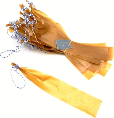 A bundle of brown paper sausage casings tied with blue and white twine, with one casing separated and laid out.