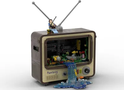 A Lego build of a vintage television set with an underwater scene inside and a figure on top.