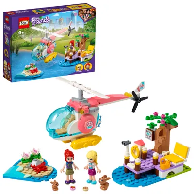 A LEGO Friends toy set featuring a helicopter, two mini-doll figures, and various accessories, displayed with its packaging.