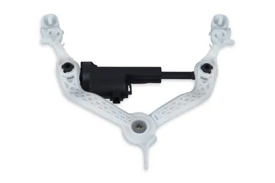 A white plastic mechanism with a black central component, isolated on a white background.