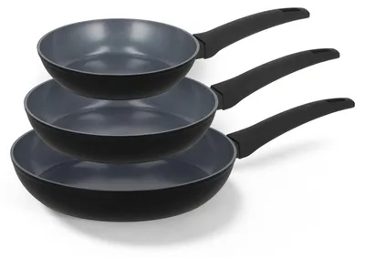 Three black frying pans stacked on top of each other.
