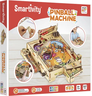 The image shows the packaging of a Smartivity Pinball Machine building kit. It features a detailed illustration of the assembled pinball machine, along with inset images demonstrating the building and playing processes. The packaging also includes text and