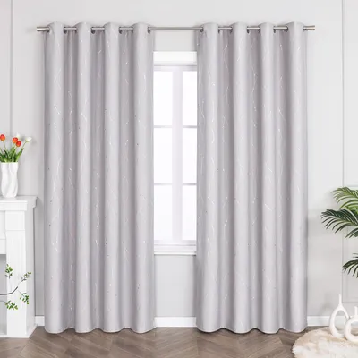 Two light gray curtains with silver stripes hang in front of a window.