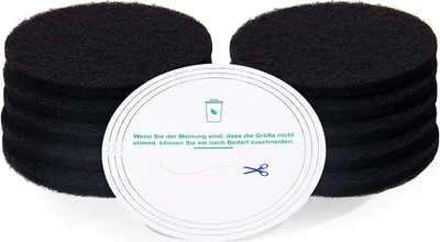 A stack of black circular filters with a white circular insert in front.
