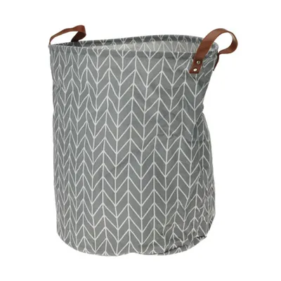 A laundry hamper with a geometric pattern and leather handles, shown against a white background.
