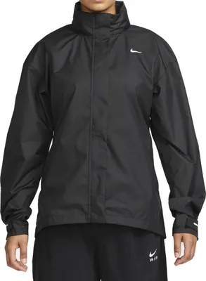 A person wearing a black Nike jacket and black pants.