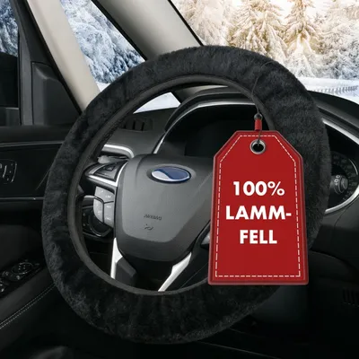 A close-up of a car's steering wheel covered with a black sheepskin cover, with a red tag hanging from it.