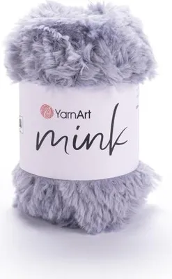 A roll of grey, fuzzy yarn with a white label.