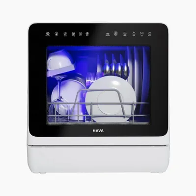 A white countertop dishwasher with its door open, showing dishes inside and a blue light. The brand name 'HAVA' is visible below the door.