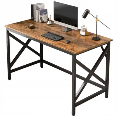 A desk with a computer, keyboard, mouse, books, and a lamp.