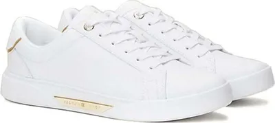 A pair of white Tommy Hilfiger sneakers with gold accents.