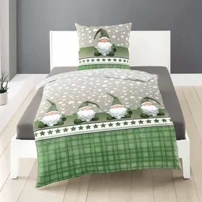 A bed with gnome-themed bedding.