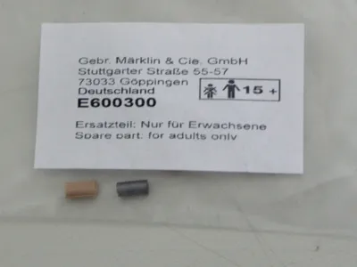 A label with product information and two small spare parts.