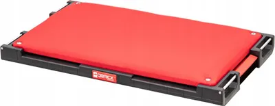 A red and black adapter plate for a seat.