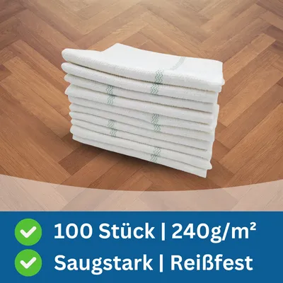 A stack of white cloths with green stripes on a wooden floor.
