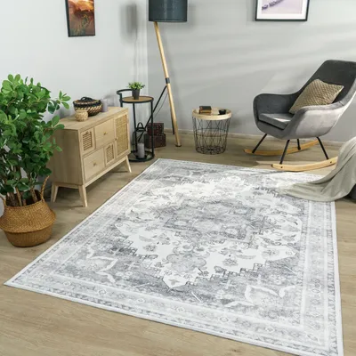 A living room scene with a rug, furniture, and decor.