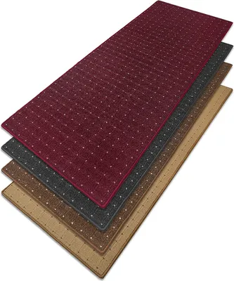 A stack of four rectangular rugs in different colors, layered diagonally on a white background.