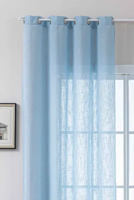 A light blue curtain hanging in front of a window.