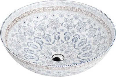 A round ceramic sink with a decorative blue and white pattern.