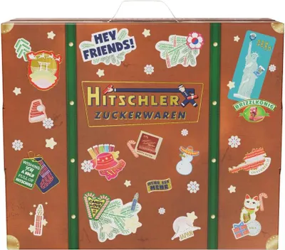 A suitcase-shaped advent calendar decorated with various stickers and the brand name.