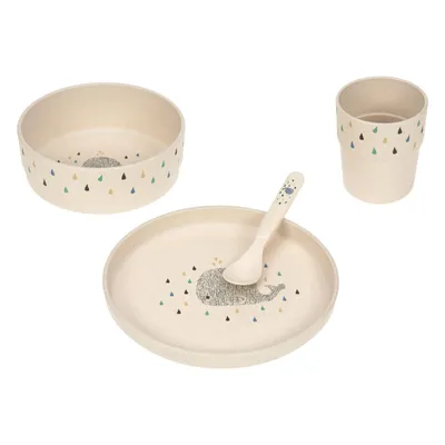 A set of children's tableware including a bowl, plate, cup, and spoon, all with a whale and raindrop pattern.