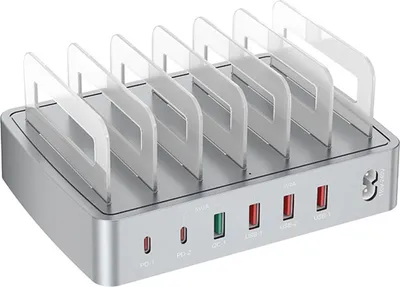 A silver multi-device charging station with clear dividers, shown from a front-side angle on a white background.