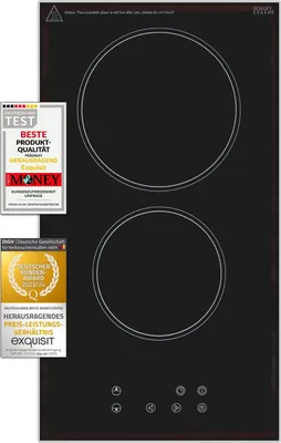 A black induction hob with two cooking zones, shown from a top-down perspective. It has several awards and certifications displayed on the left side.