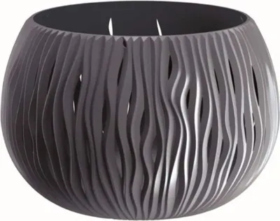 A gray planter with a wavy, cut-out design.