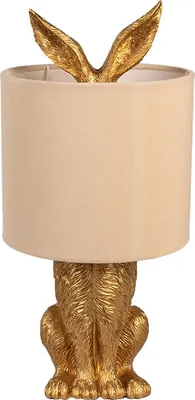 A gold-colored rabbit-shaped table lamp with a beige lampshade.