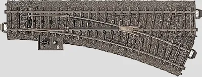 A model railroad track switch with a manual control lever.