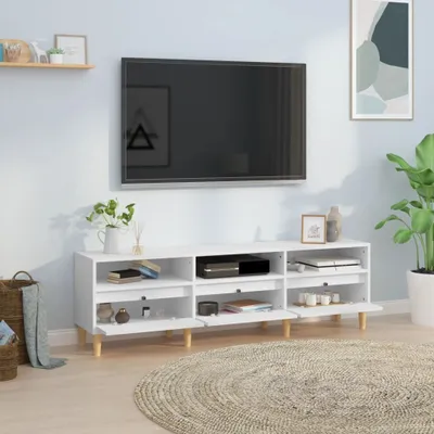 A white TV stand with a television mounted above it, in a room setting.