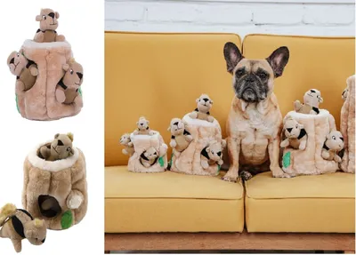 A French bulldog sits on a yellow couch surrounded by plush dog toys shaped like tree stumps with small animal plushies peeking out.