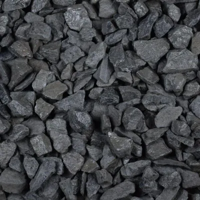 A close-up, overhead view of a pile of dark gray gravel stones.