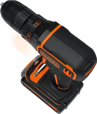 A black and orange cordless drill with a battery pack attached, shown from a high angle.