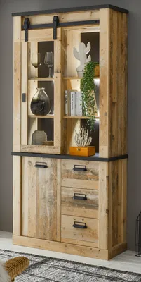 A tall wooden cabinet with glass doors and drawers, styled with decorative items.