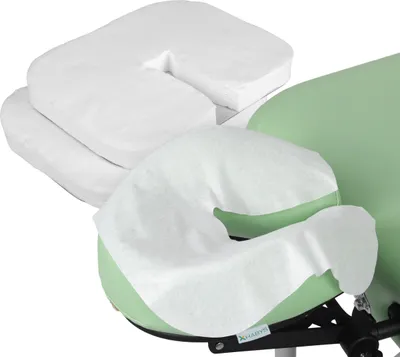 A close-up view of disposable face cradle covers on a massage table.