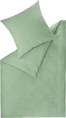 A folded green duvet cover and pillowcase are laid out on a white background.