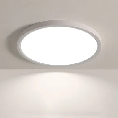 A round, flat LED ceiling light mounted on a white ceiling, casting a soft light downwards.