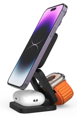 A black 3-in-1 wireless charging stand holding a purple iPhone, a white pair of AirPods, and an orange Apple Watch.
