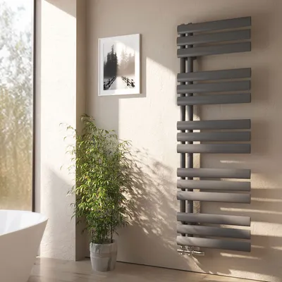 A modern bathroom with a large window, a bathtub, a plant, and a grey vertical radiator.