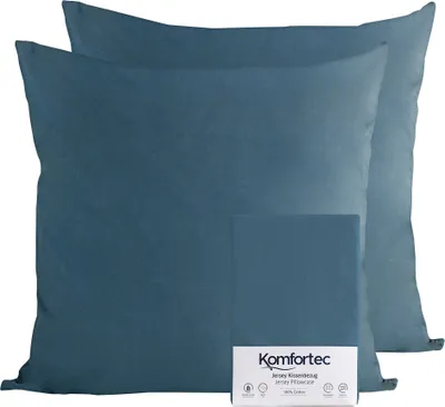 Two teal pillowcases are shown on a white background, with a small folded pillowcase and a product label in the foreground.